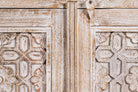 Close up image of a white washed cabinet handcrafted from mango wood with engraved doors; artisanal Indian mango wood furniture, 90 × 90 × 40 cm.