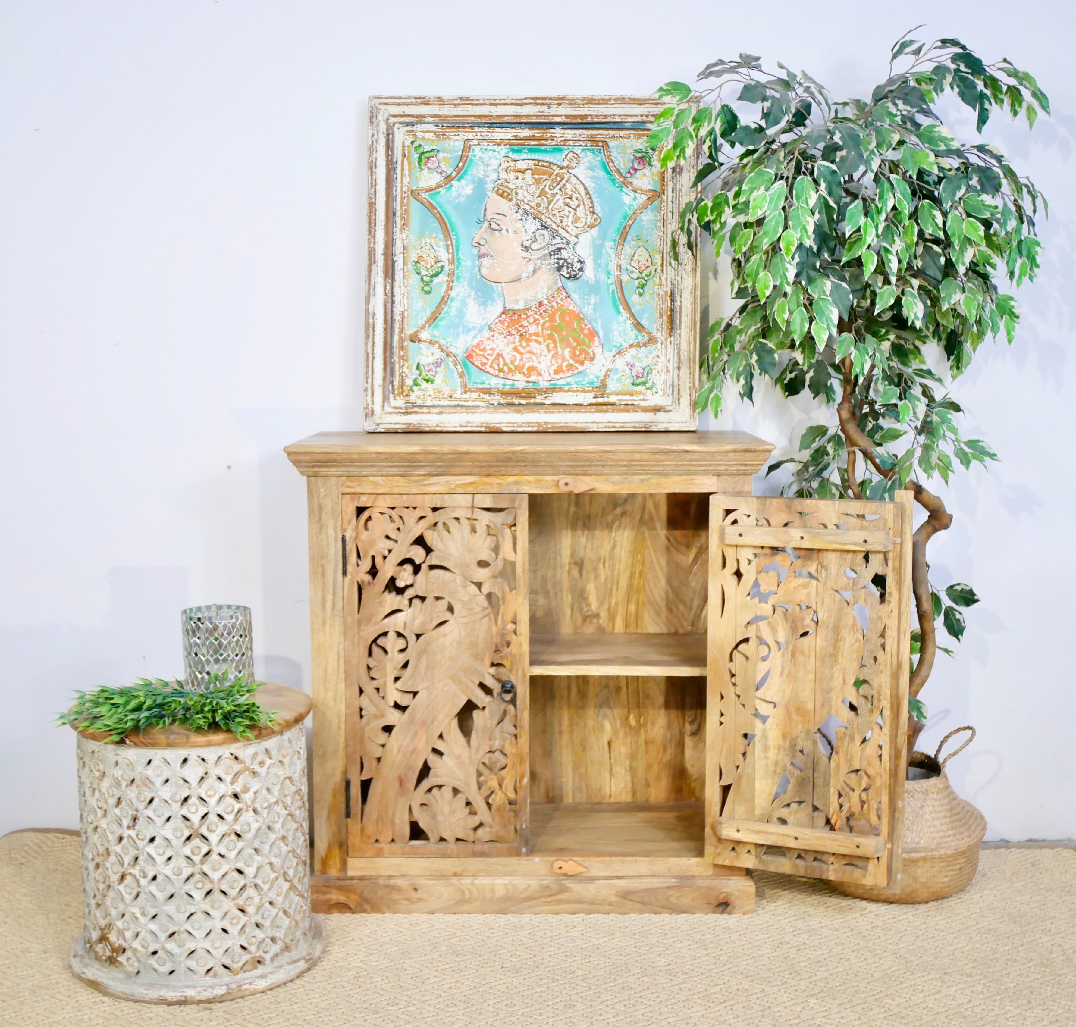 Open door image of a white washed wooden cabinet with hand-carved peacock doors, handcrafted mango wood furniture, Mediterranean-style storage unit, 90 × 90 × 40 cm.