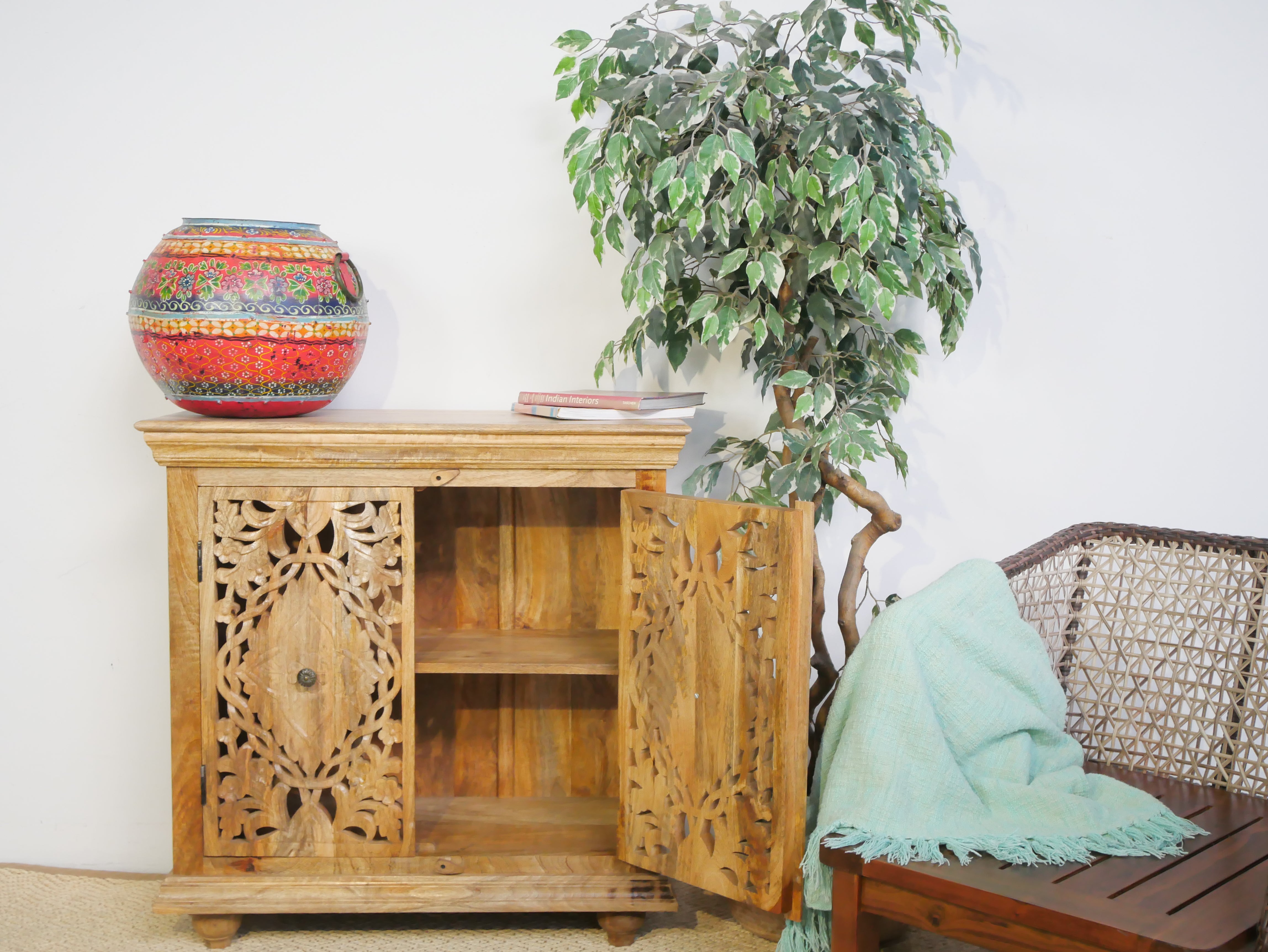 Open door image of a carved wood furniture cupboard in solid mango wood with handmade floral carvings, Mediterranean-style, 90 × 90 × 40 cm.
