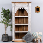 Hand-carved mango wood bookshelf with arched frame and whitewashed finish – carved wooden furniture and mango wood shelving with Indian-inspired design.