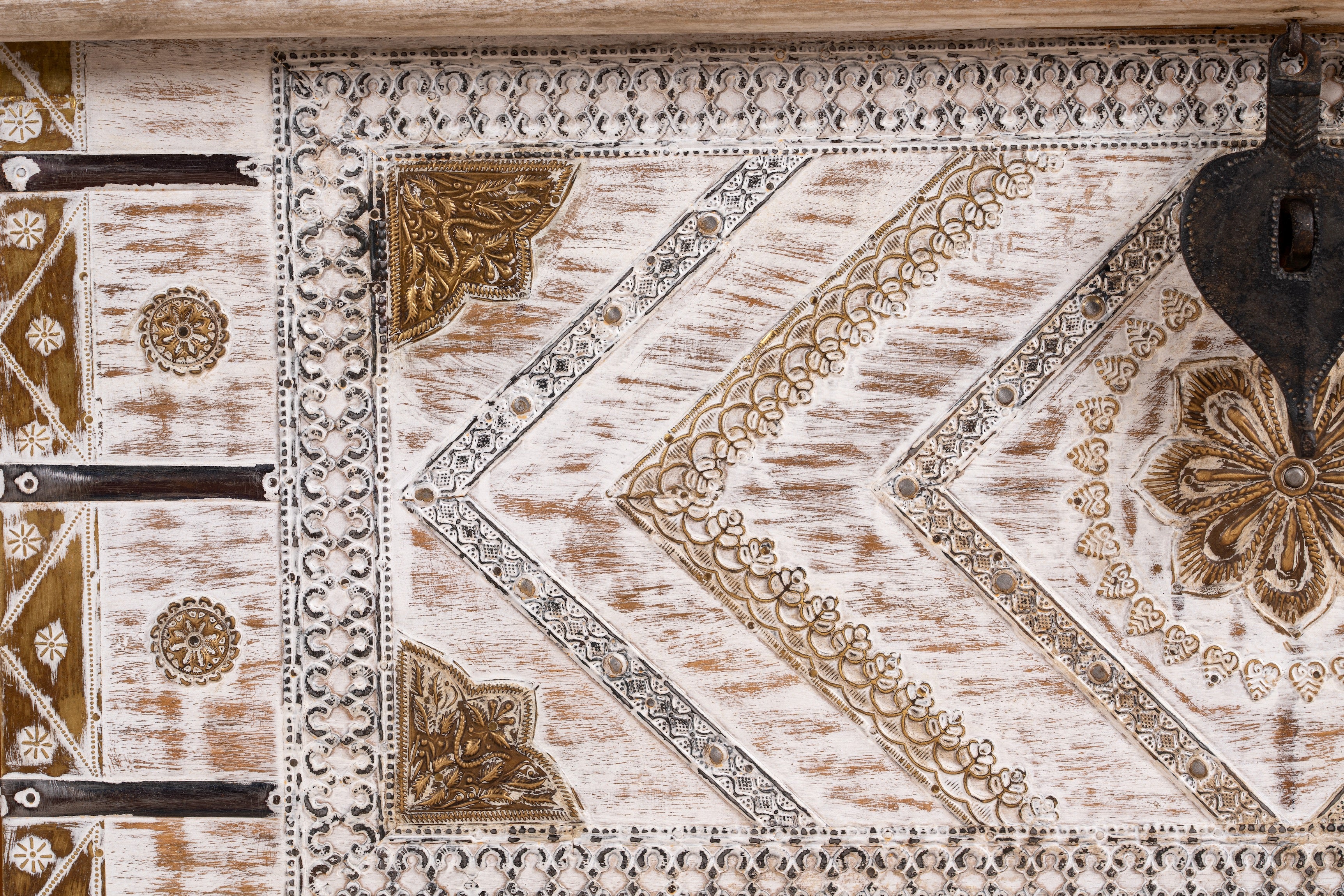 Close up image of a handcrafted mango wood chest with brass inlays and carvings – wood chest box for boho style interiors, perfect as coffee table or bedroom storage.